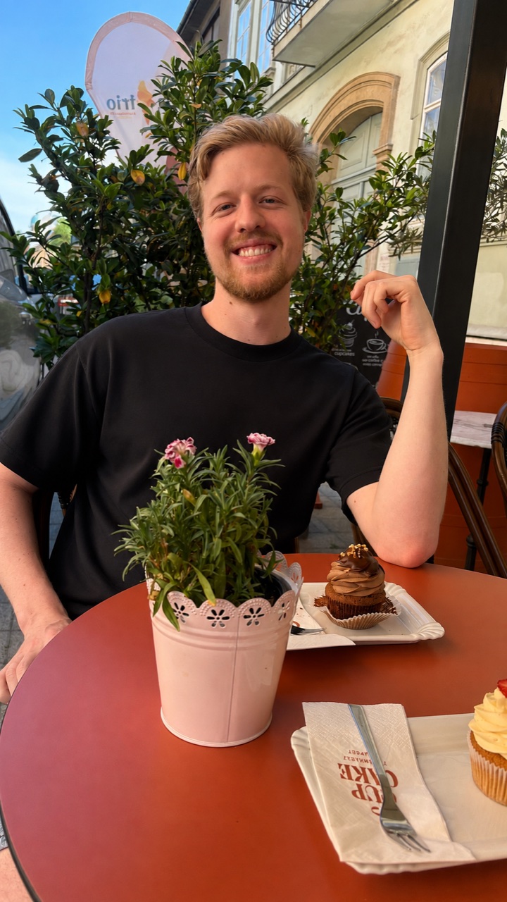 Nico Nice smiling at a café table