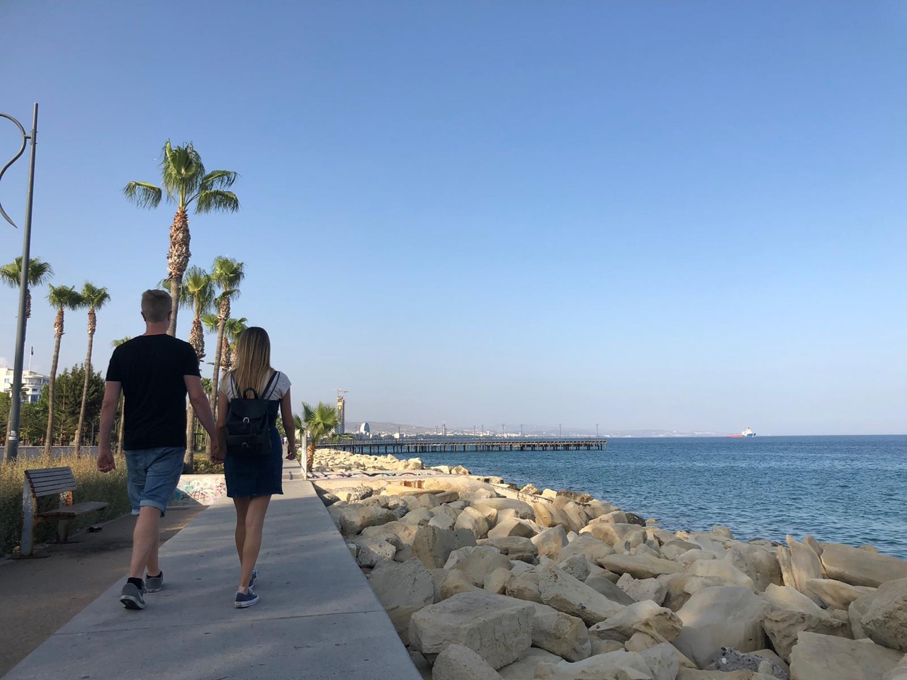 Nico Nice and Jamie Young walking together along a sunny seafront